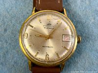 Close-up of Envoy watch dial showing brand, 17 jewel text, Incabloc marking, date window