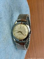 Front view showing dial, case and bracelet