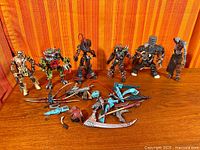 Seven Spawn action figures standing with loose weapons laid out