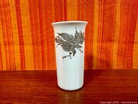 Front view showing grey floral decoration on white porcelain vase