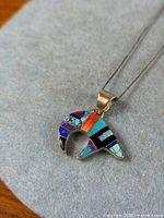 Front view of bear pendant showing multi-colour stone inlay