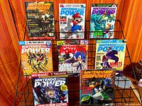 Front view of all nine Nintendo Power magazines on rack