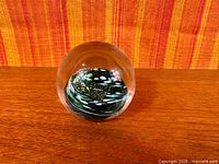 full view of spherical paperweight showing interior design