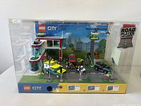 Front view of Lego City illuminated display showing vehicles, building and control panel