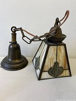 Side view of lamp showing shade, chain and ceiling cap
