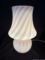 Front view of soft pink Murano glass mushroom lamp illuminated