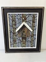Front view of framed painting showing birdhouse among birch trees