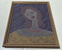 Full view of framed painting lying flat