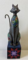 Front view of signed Jim Shore "Leona" cat figurine on quilt block base