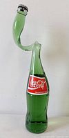 Front view of twisted Coca-Cola bottle