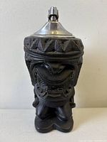 Front view showing carved Tiki face and lighter insert