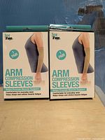 Front view of two sealed Total Vision Arm Compression Sleeves boxes