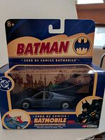 Front of boxed Corgi 1:43 Batmobile showing branding and vehicle