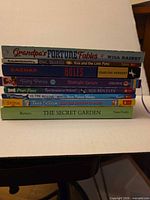 Stack of eight youth books showing titles and authors