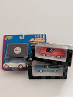 Group shot of three boxed 1:43 scale diecast convertible cars