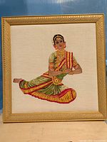 Full view of framed embroidered dancer artwork