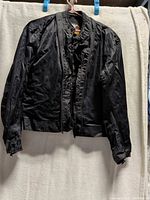 Full view of black jacket front on hanger