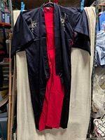 Full view of kimono front showing black exterior and red lining