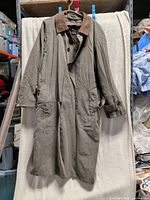 Full view of olive long coat hanging