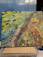 Full view of multicolored abstract acrylic painting on easel