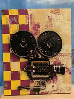 Front view of canvas print showing vintage film camera graphic and checkerboard accent