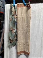 Full view of both scarves hanging side by side