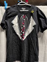 Front view of black T-shirt showing full tuxedo graphic