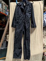 Full front view of the dark navy Dakota coverall hanging