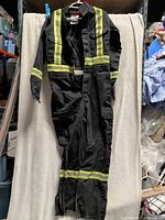 Front view of black Dakota FR coveralls with reflective tape