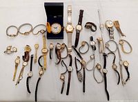 Overview of all 37 vintage ladies watches arranged on table