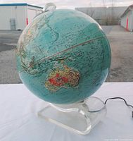 Full view of globe left side showing Australia and acrylic base