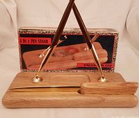 Complete set assembled with two Sheaffer pens in brass holders on oak stand, letter opener in foreground, retail box behind