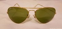Front view showing gold frame and green lenses with Ray-Ban logo