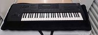 Full view of Korg i3 keyboard resting on padded case