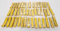 Overview of 45 yellow promotional measuring tapes in rows, all sealed