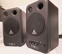 Front angle of both Behringer MS16 speakers, showing grille and logo