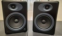 Front view of both Audioengine 5 speakers showing drivers and condition