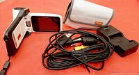 Camera, case, charger, USB and A/V cables laid out