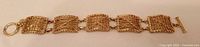 Full view of bracelet front showing square woven links and toggle clasp