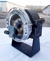 Oblique front-left view showing compass face, housing, stand