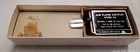 Switch in open box showing data plate and vane