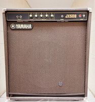 Front view of Yamaha JX50B amplifier showing grille, control panel, logo and patch repair