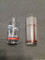 Front view of both souvenir glasses showing graphics