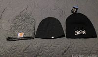 Front view of three toques showing logos and colours