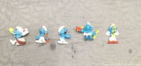 Front view of all five Smurf figurines standing