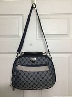 Front view of Baggo cosmetic bag showing pattern, front pocket, strap attached