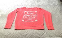 Front view showing Coca-Cola graphic and overall garment