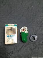 Front view of label maker, tape roll and boxed packaging