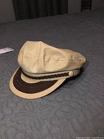 Cap left side view showing braided band and visor