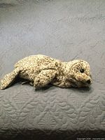 Full side view of speckled plush harbour seal puppet